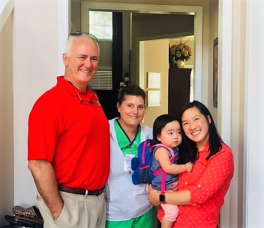 Rep. Garry Smith (left) visits home health care client Emma (held), mom Gina (right) and their in-home BAYDA nurse Danielle (second from left).